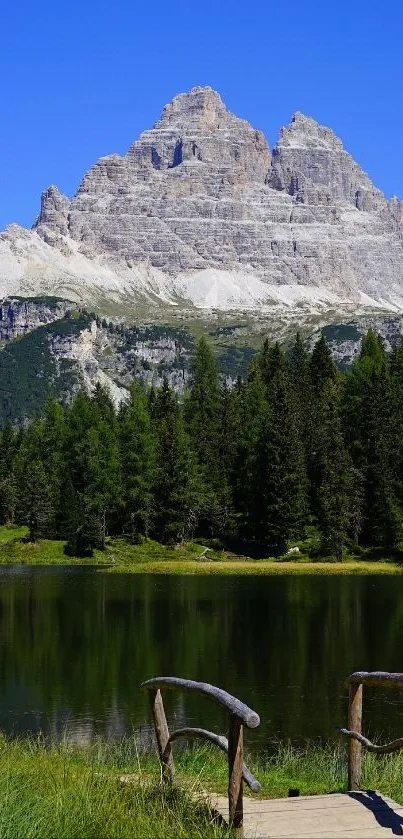 Majestic mountain reflected in a serene lake under a clear blue sky.