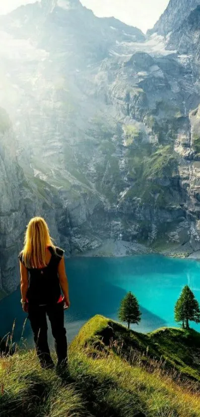 Woman overlooking turquoise lake and majestic mountains.