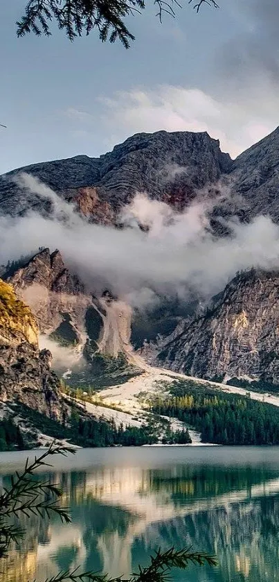 Scenic view of a mountain lake with mist and greenery surrounding.