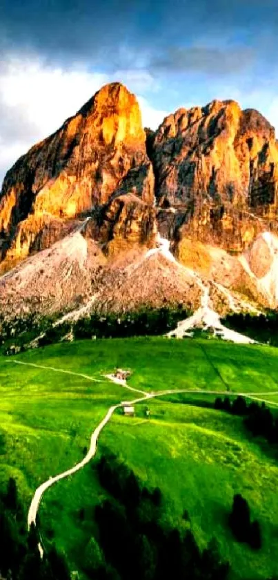 Stunning mountain landscape with green fields and rocky cliffs under a vibrant sky.