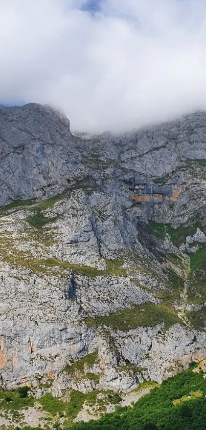 Breathtaking mountain landscape with clouds and cliffs.