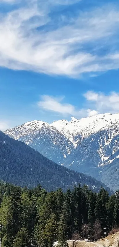 Scenic mountain landscape under a bright blue sky with lush green forests.