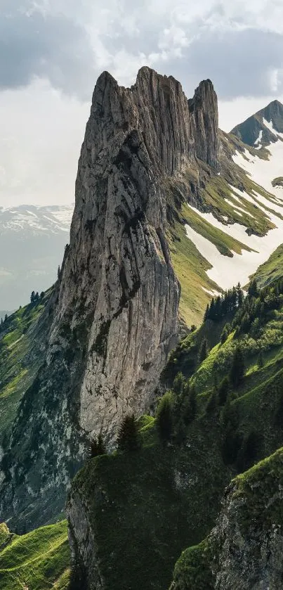 A majestic mountain with snow and greenery.