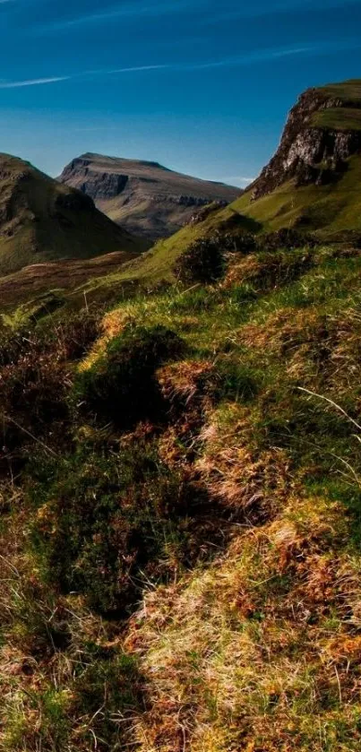 Majestic green mountain landscape under blue skies, perfect for mobile wallpaper.