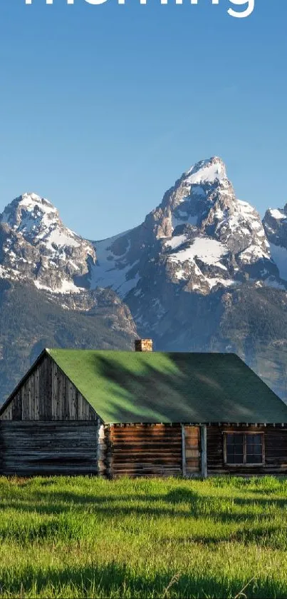 Rustic cabin with mountains and blue sky.