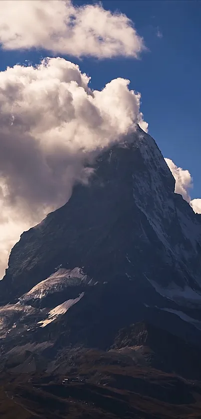 Majestic mountain peak with clouds in stunning phone wallpaper.