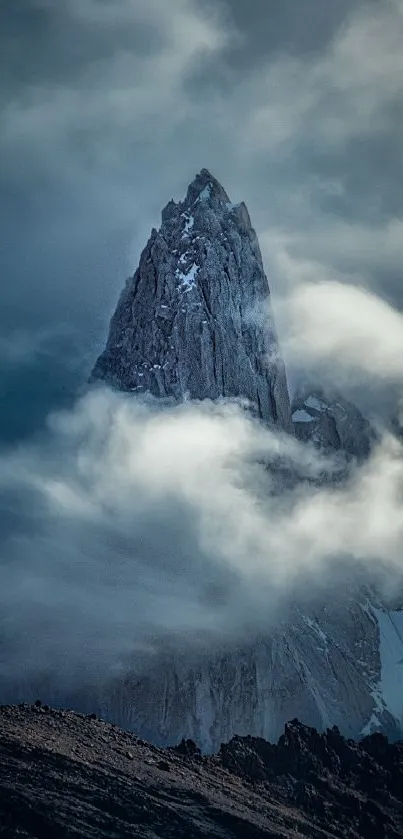 Majestic mountain peak shrouded in clouds.