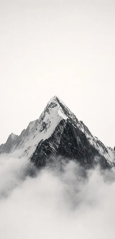 Mountain peak surrounded by clouds with gray tones.