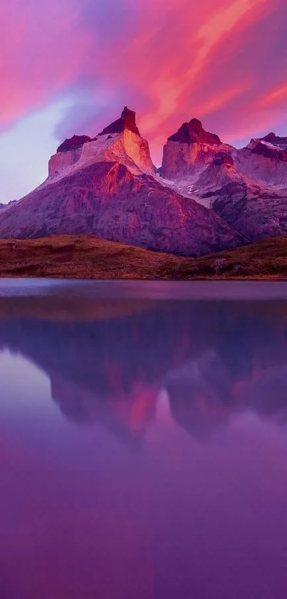 Mountains and lake under purple sunset sky.