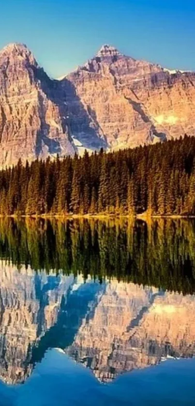 Mountain reflection in a clear lake with blue sky background.