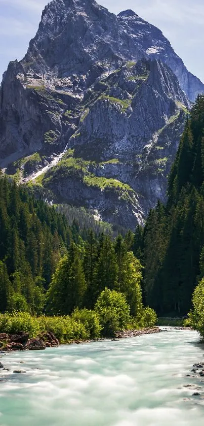Majestic mountain with a flowing river and lush green forest.