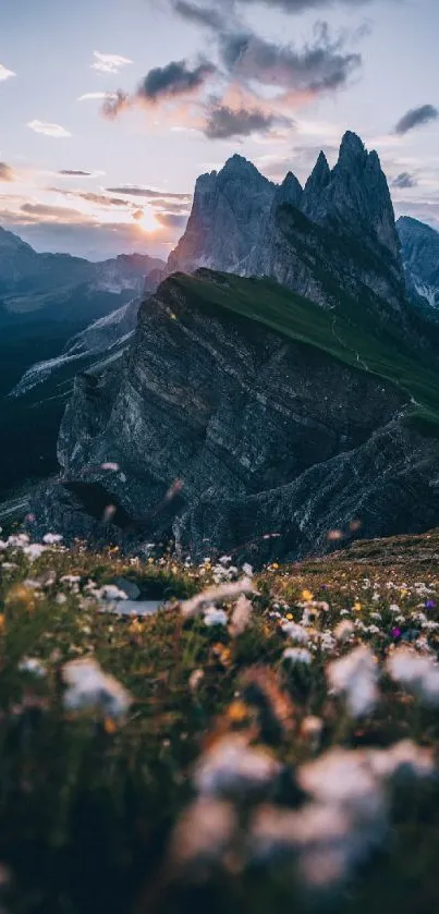 Majestic mountain view at sunrise with blurred flowers in the foreground.