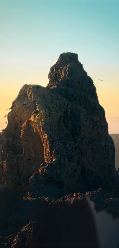 Majestic mountain with sunrise and sky blue gradient.