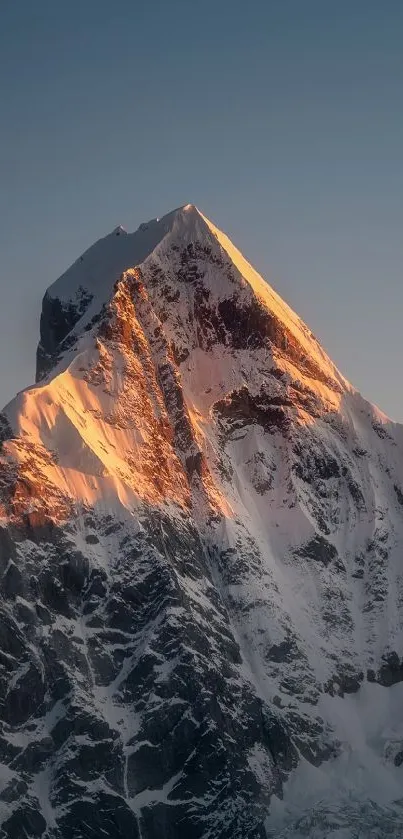 Beautiful mountain peak illuminated by soft sunrise light.