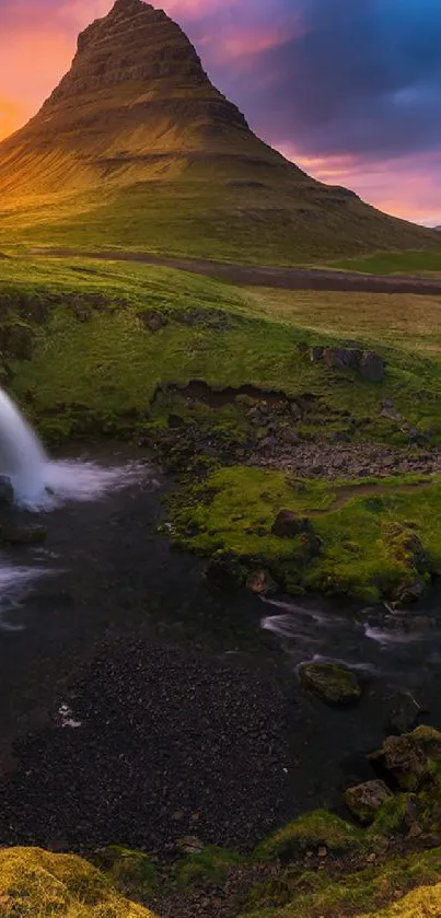 Sunset over a majestic mountain with waterfalls and colorful skies.