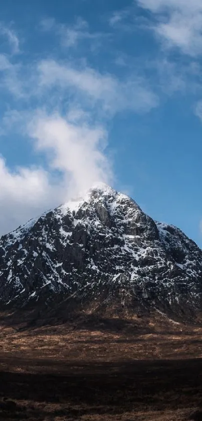 Majestic snow-capped mountain under a vivid blue sky wallpaper.