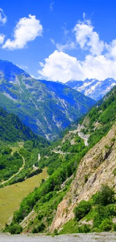 Beautiful mountain valley with lush greenery and blue sky wallpaper.