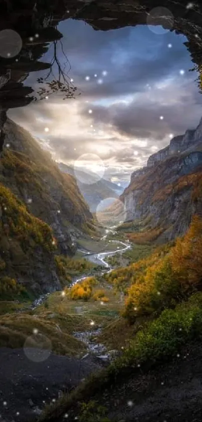 Mountain valley view from a cave with dramatic skies and lush greenery.