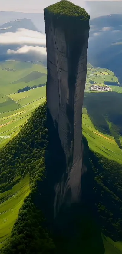 Vertical mountain and green fields with misty clouds in a scenic landscape.