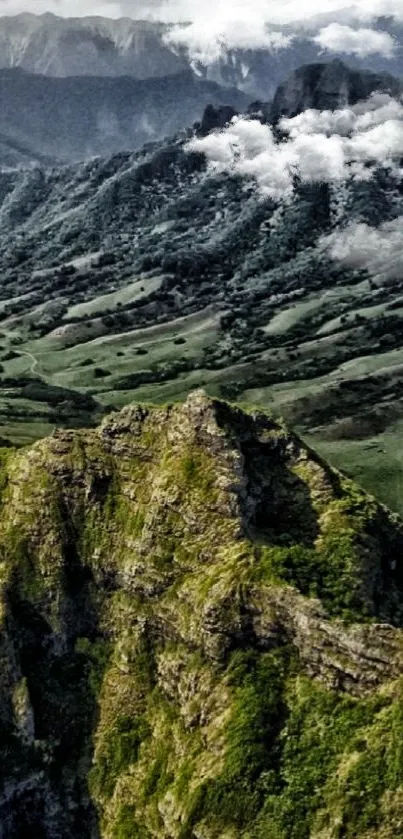 Stunning green mountain landscape with towering peaks and lush valleys.