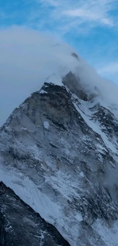 Majestic snow-covered mountain peak against a blue sky wallpaper.