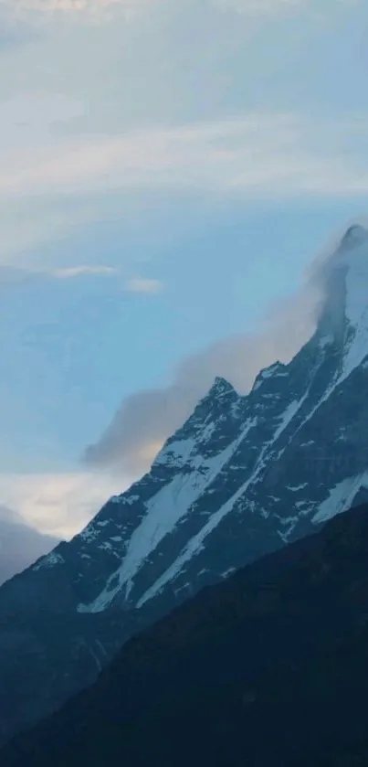 Snow-capped mountain under a blue sky.