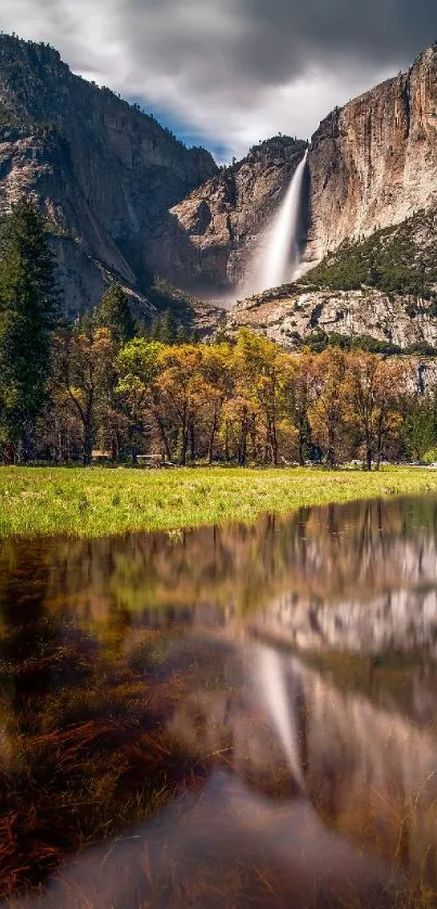 Stunning waterfall cascading down a mountain with reflection in a serene meadow.