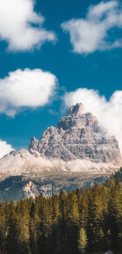 Mountain peak surrounded by clouds and blue sky.