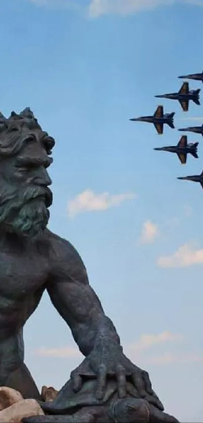 Statue of Poseidon with jets flying overhead against a blue sky.