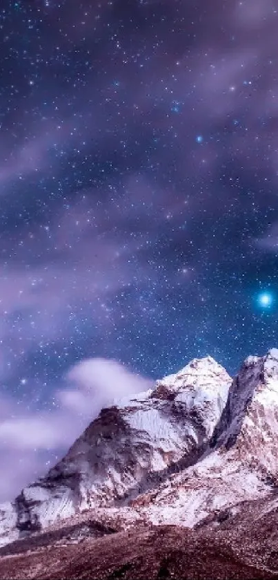 Snowy mountain under a starry purple night sky.