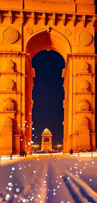 Illuminated arch monument at night, snowflakes in the foreground.