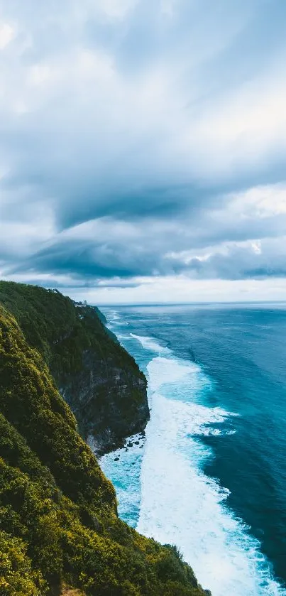 Majestic ocean cliff with vibrant blue sea and lush greenery under a dramatic sky.