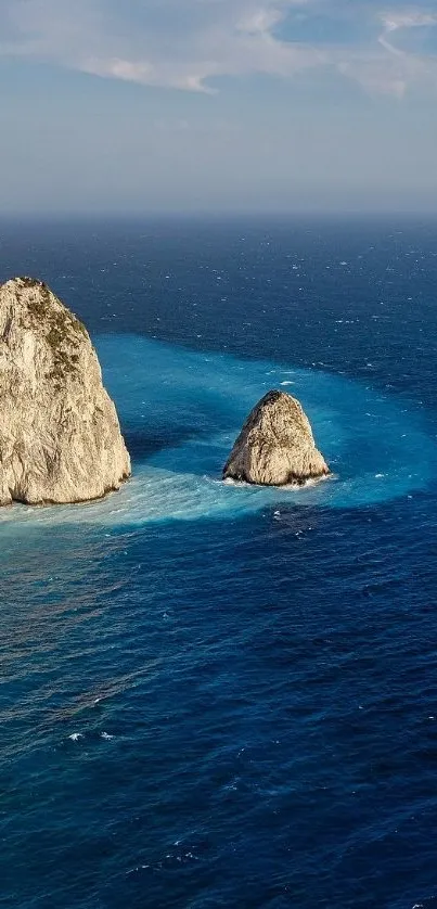 Breathtaking view of rocky cliffs by the ocean under a clear blue sky.