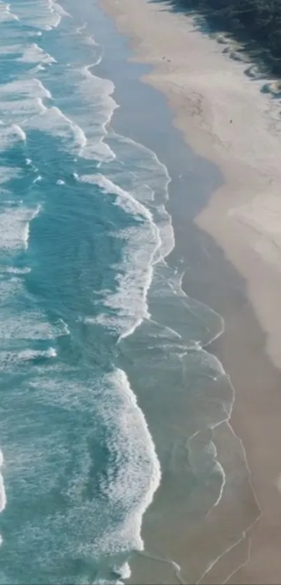 Turquoise waves gently washing a sandy beach under clear skies.