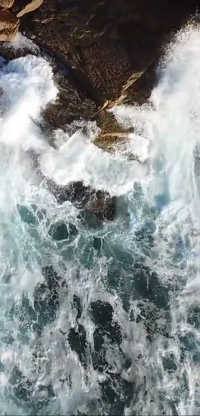 Aerial view of waves crashing against rocks.