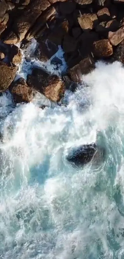 Aerial view of powerful ocean waves crashing against rocky shore.