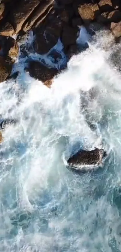 Aerial view of ocean waves crashing onto coastal rocks.