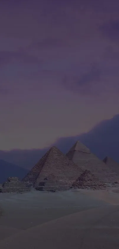 Pyramids at dusk in a serene twilight setting with purple sky.