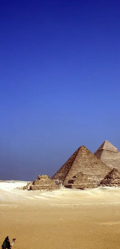 Stunning view of pyramids under a vibrant blue sky at sunset.