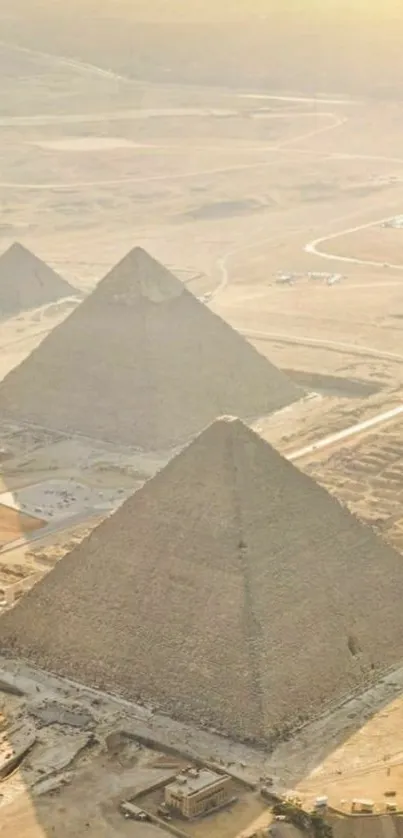 Golden pyramids in Egyptian desert at sunset.