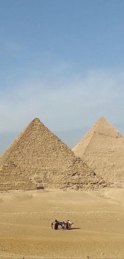 Pyramids of Egypt under a blue sky.