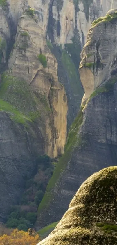 Wallpaper of majestic rock formations with greenery.