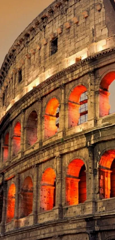 Roman Colosseum glowing in orange tones at night.