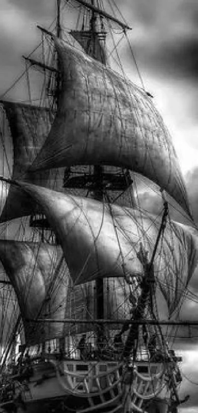 Majestic sailing ship with dramatic, cloudy skies in black and white.