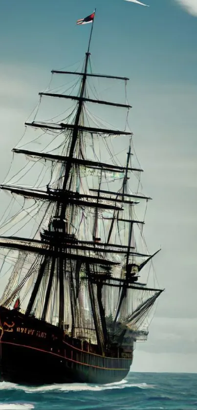 Majestic vintage sailing ship on a calm ocean with a clear sky.