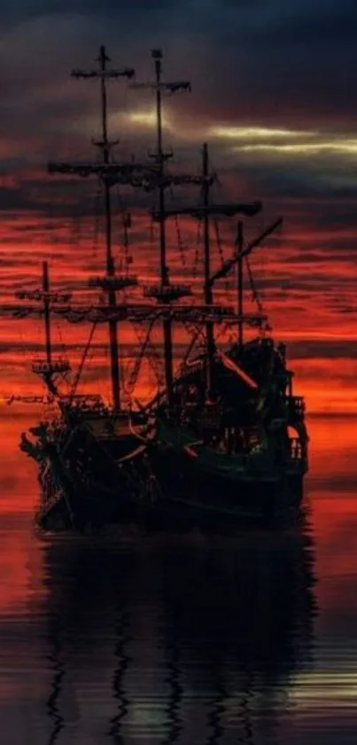 Silhouetted ship against orange sunset over calm ocean waters.