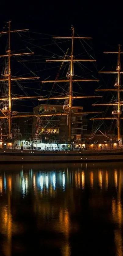 Majestic tall ship illuminated at night in a tranquil harbor.