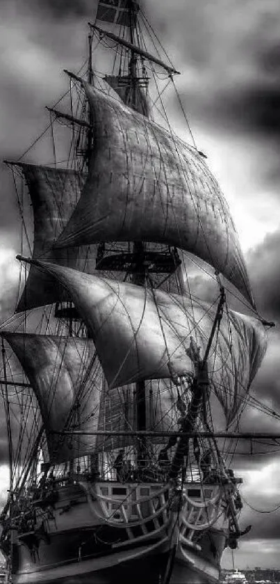 Majestic ship with sails in a stormy gray sky.