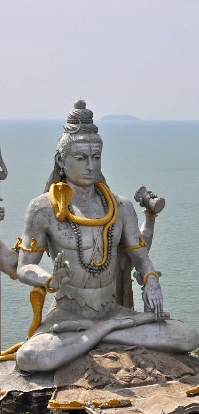 Grand Shiva statue by the sea, bright and serene.