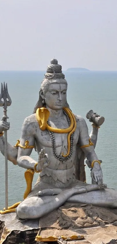 Majestic Shiva statue by the ocean, perfect for a serene mobile wallpaper.